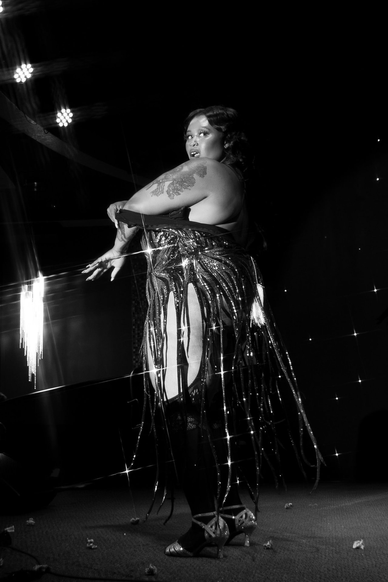 Burlesque artist in a sparkling costume on stage