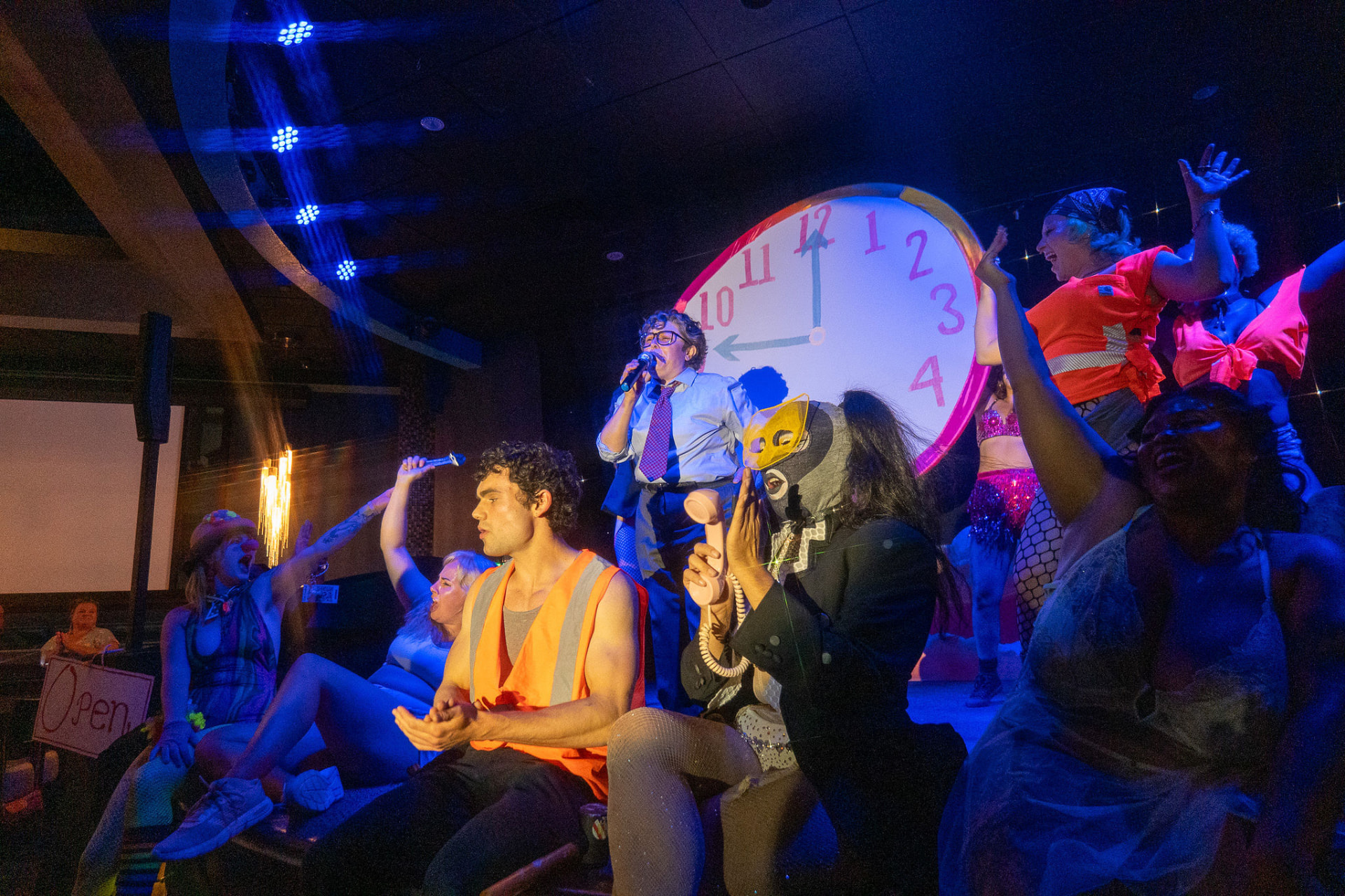 Wild Nights cast performing beneath a giant clock